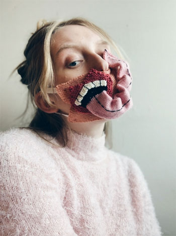 Ýr Jóhannsdóttir (Ýrúrarí) wearing a mask cover she knit during Covid-19 stay-at-home orders in Reykjavik, Iceland. 